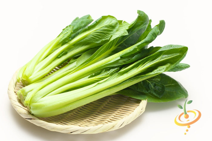 Fresh mustard tendergreen leaves on a woven bamboo tray
