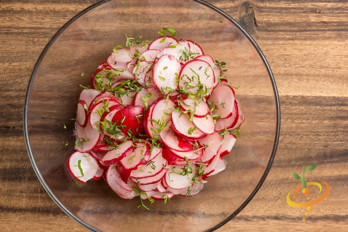 Bright red Sparkler radish seedlings growing in soil, from SeedsNow, ready for planting in vegetable gardens.